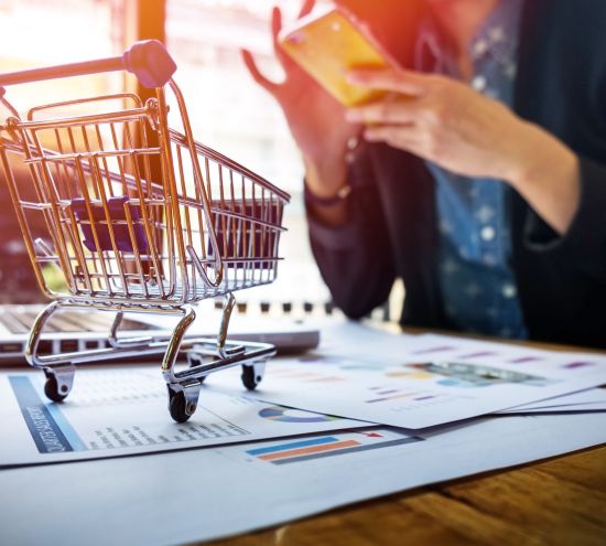 Cropped image of woman inputting card information and key on phone or laptop while shopping online.